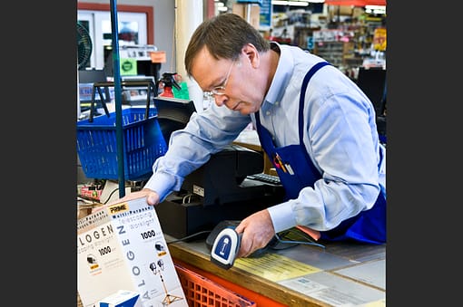 A man in a hardware store scanning product
